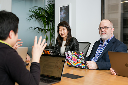 People around a table during a design review meeting