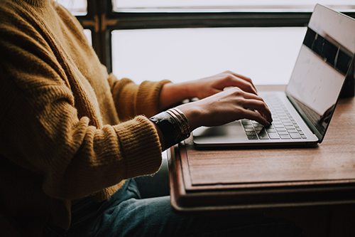 Person sitting at a computer and typing