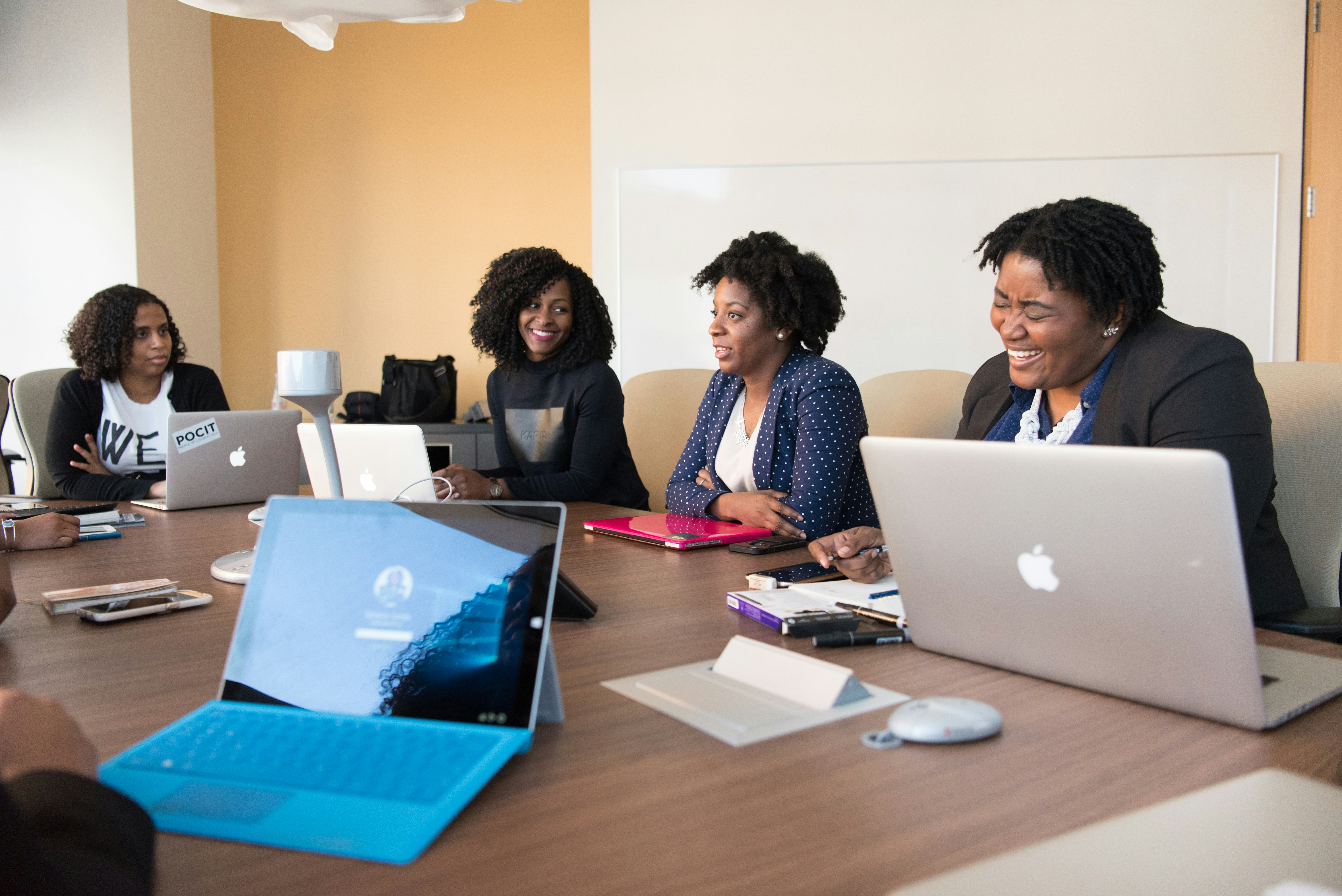 Women sitting around a table having a business meeting.