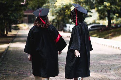 High School students just graduated, wearing their graduation regalia