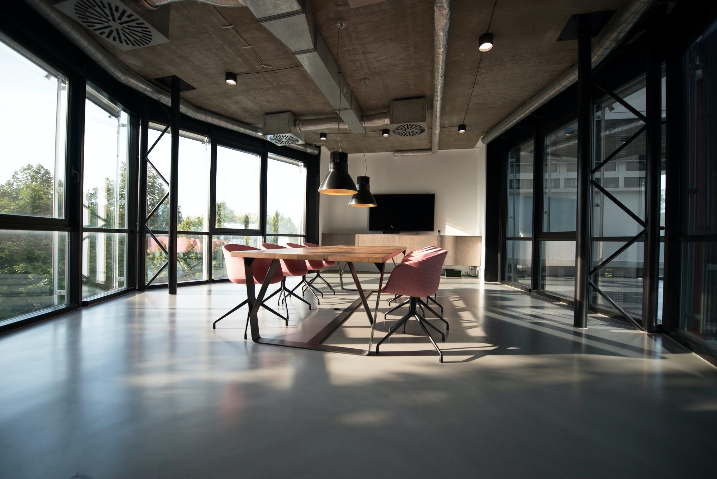 An empty conference table bathed in the afternoon sunlight.